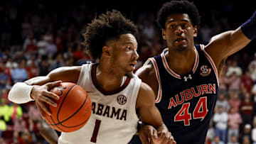 Jan 24, 2024; Tuscaloosa, Alabama, USA; Alabama Crimson Tide guard Mark Sears (1) dribbles around Auburn Tigers center Dylan Cardwell (44) on the way to the basket during the second half at Coleman Coliseum. Mandatory Credit: Butch Dill-Imagn Images