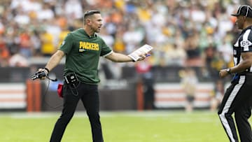 Sep 21, 2025; Cleveland, Ohio, USA; Green Bay Packers head coach Matt LaFleur argues a call with line judge Walt Coleman IV (65) during the fourth quarter at Huntington Bank Field. Mandatory Credit: Scott Galvin-Imagn Images