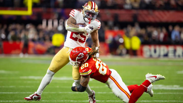 Feb 11, 2024; Paradise, Nevada, USA; San Francisco 49ers running back Elijah Mitchell (25) is tackled by Kansas City Chiefs safety Justin Reid (20) 