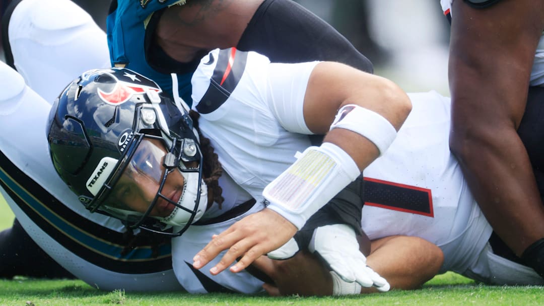 Houston Texans quarterback CJ. Stroud (7) is sacked by Jacksonville Jaguars defensive end Travon Walker (44) during the first quarter of an NFL football matchup at EverBank Stadium, Sunday, Sept. 21, 2025, in Jacksonville, Fla. [Corey Perrine/Florida Times-Union]