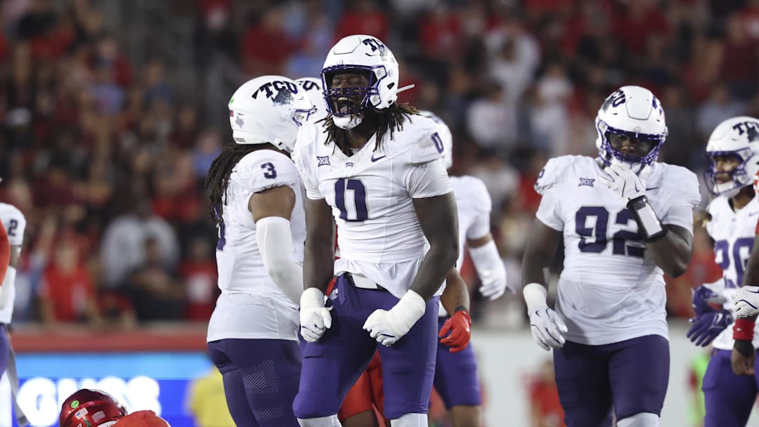Nov 22, 2025; Houston, Texas, USA; TCU Horned Frogs defensive lineman Zachary Chapman (0) reacts after making a tackle on Houston Cougars quarterback Conner Weigman (1) during the fourth quarter at TDECU Stadium. Mandatory Credit: Troy Taormina-Imagn Images