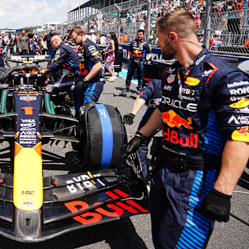 May 4, 2024; Miami Gardens, Florida, USA; Crewmembers work on the car of Red Bull Racing driver Max Verstappen (1) on the grid before the F1 Sprint Race at Miami International Autodrome. Mandatory Credit: John David Mercer-Imagn Images