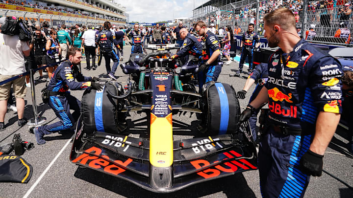 May 4, 2024; Miami Gardens, Florida, USA; Crewmembers work on the car of Red Bull Racing driver Max Verstappen (1) on the grid before the F1 Sprint Race at Miami International Autodrome. Mandatory Credit: John David Mercer-Imagn Images