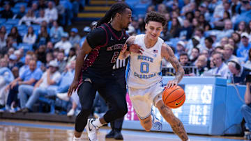 Nov 14, 2025; Chapel Hill, North Carolina, USA; North Carolina Tar Heels guard Kyan Evans (0) drives on North Carolina Central Eagles guard Dionte Johnson (2) during the second half at Dean E. Smith Center. 