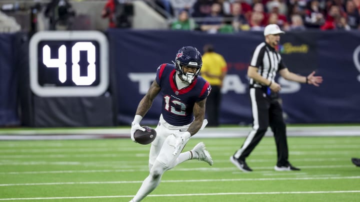 Jan 13, 2024; Houston, Texas, USA; Houston Texans wide receiver Nico Collins (12) runs with the ball during the second quarter in a 2024 AFC wild card game at NRG Stadium. Mandatory Credit: Thomas Shea-USA TODAY Sports