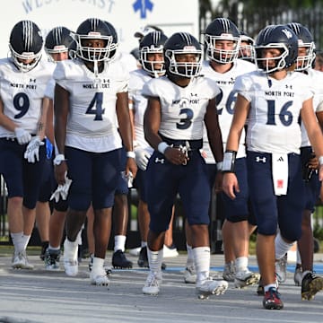 The North Port Bobcats march onto the field as Darth Vader's Imperial March music plays on the public address system. The IMG Academy Blue Ascenders hosted the North Port Bobcats for a Thursday night varsity football game in Bradenton.