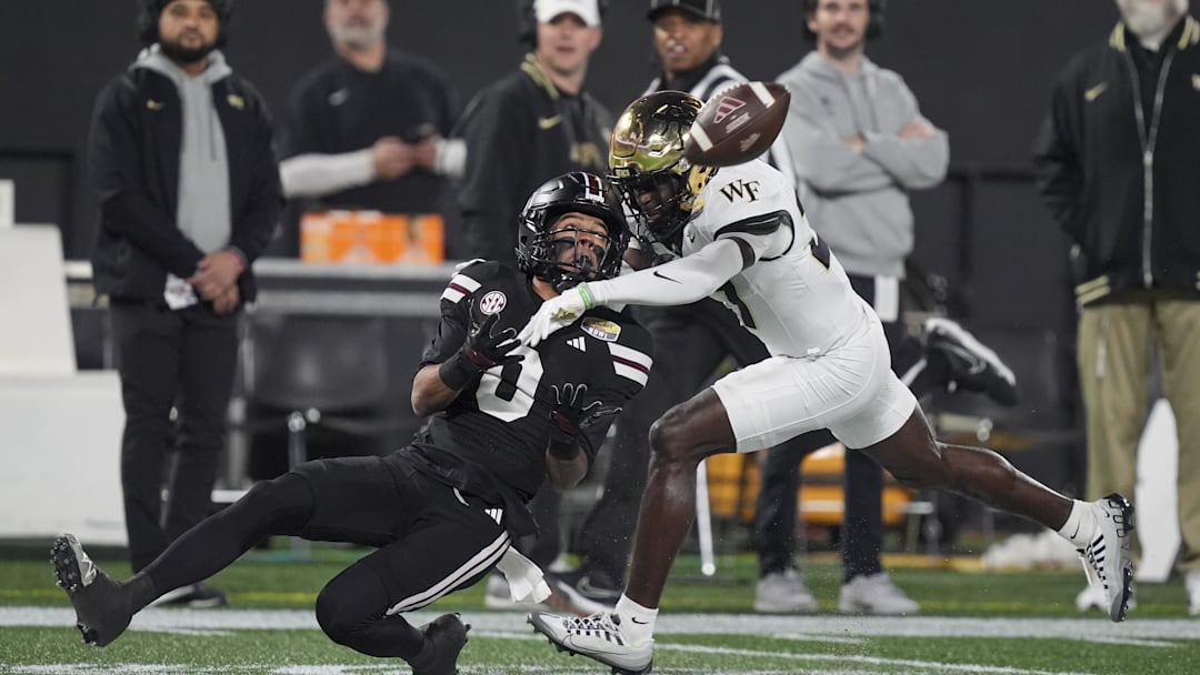 Jan 2, 2026; Charlotte, NC, USA; Mississippi State Bulldogs wide receiver Brenen Thompson (0) makes a opening play catch defended by Wake Forest Demon Deacons defensive back Karon Prunty (3) during the first quarter at Bank of America Stadium. Mandatory Credit: Jim Dedmon-Imagn Images