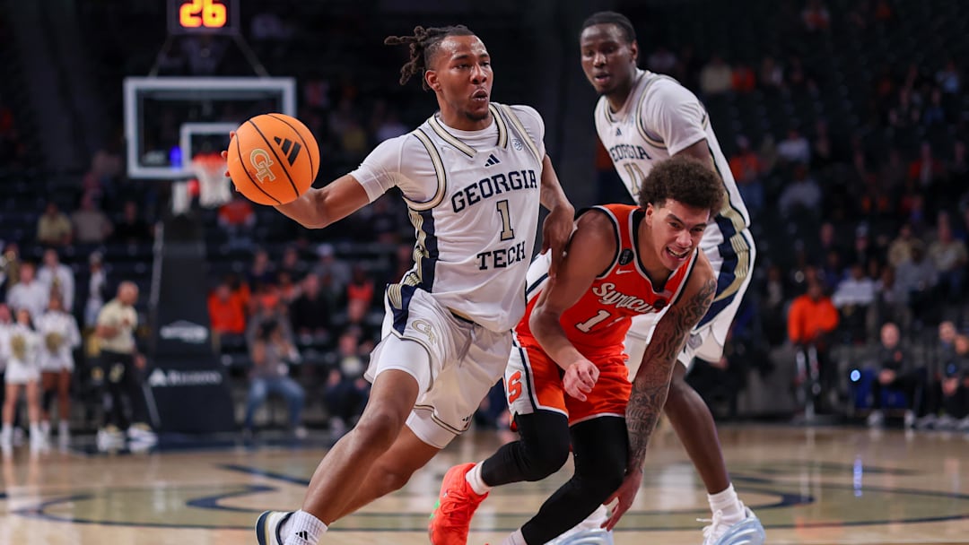 Jan 6, 2026; Atlanta, Georgia, USA; Georgia Tech Yellow Jackets guard Lamar Washington (1) drives past Syracuse Orange guard Naithan George (11) in the second half at McCamish Pavilion. Mandatory Credit: Brett Davis-Imagn Images
