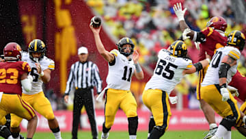 Nov 15, 2025; Los Angeles, California, USA; Iowa Hawkeyes quarterback Mark Gronowski (11) throws against the Southern California Trojans during the first half at the Los Angeles Memorial Coliseum. Mandatory Credit: Gary A. Vasquez-Imagn Images