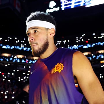 Dec 12, 2023; Phoenix, Arizona, USA; Phoenix Suns guard Devin Booker (1) is introduced before the game against the Golden State Warriors at Footprint Center. Mandatory Credit: Mark J. Rebilas-USA TODAY Sports