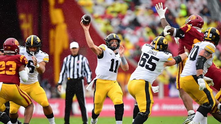 Nov 15, 2025; Los Angeles, California, USA; Iowa Hawkeyes quarterback Mark Gronowski (11) throws against the Southern California Trojans during the first half at the Los Angeles Memorial Coliseum. Mandatory Credit: Gary A. Vasquez-Imagn Images