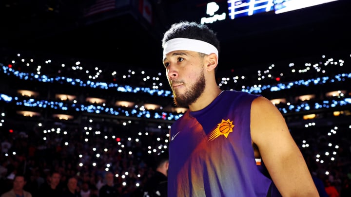 Dec 12, 2023; Phoenix, Arizona, USA; Phoenix Suns guard Devin Booker (1) is introduced before the game against the Golden State Warriors at Footprint Center. Mandatory Credit: Mark J. Rebilas-USA TODAY Sports