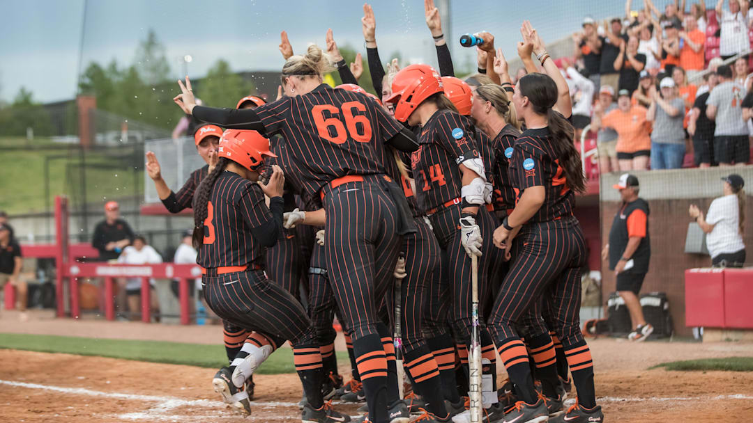 May 17, 2025; Fayetteville, AR, USA;  Oklahoma State Cowgirls players greet catcher Amanda Hasler (3) at home after a grand slam during the third inning against the Indiana Hoosiers. Oklahoma State won 16-8.  Mandatory Credit: Brett Rojo-Imagn Images