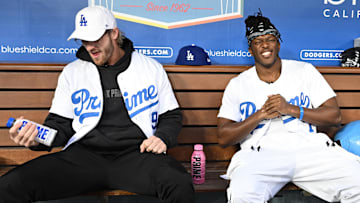 Mar 31, 2023; Los Angeles, California, USA;  American YouTuber Logan Paul and British YouTuber KSI, both cruiserweight professional boxers, pose for photos in the dugout prior to the game between the Los Angeles Dodgers and the Arizona Diamondbacks at Dodger Stadium. Mandatory Credit: Jayne Kamin-Oncea-Imagn Images