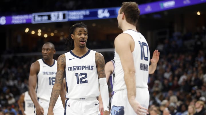 Memphis Grizzlies guard Ja Morant (12) reacts toward Memphis Grizzlies guard Luke Kennard (10) after a foul call during the first half against the Sacramento Kings at FedExForum. Mandatory Credit: