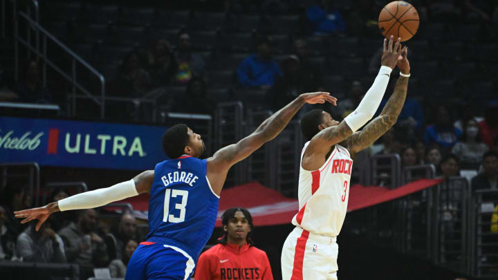 Oct 31, 2022; Los Angeles, California, USA; Houston Rockets guard Kevin Porter Jr. (3) shoots the ball defended by LA Clippers guard Paul George (13) in the first half  at Crypto.com Arena. Mandatory Credit: Richard Mackson-USA TODAY Sports