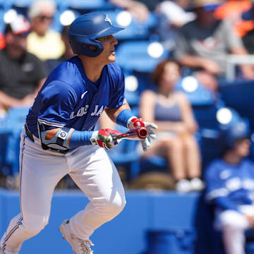 Dunedin, Florida, USA; Toronto Blue Jays outfielder Daulton Varsho (5) hits an RBI single against the Baltimore Orioles in the first inning during spring training at TD Ballpark.
