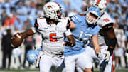 Nov 4, 2023; Chapel Hill, North Carolina, USA;  Campbell Fighting Camels quarterback Hajj-Malik Williams (6) looks to pass as North Carolina Tar Heels defensive lineman Beau Atkinson (12) pressures in the third quarter at Kenan Memorial Stadium. Mandatory Credit: Bob Donnan-Imagn Images