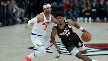 Mar 12, 2025; Portland, Oregon, USA; Portland Trail Blazers guard Scoot Henderson (00) dribbles the ball against New York Knicks shooting guard Josh Hart (3) during overtime at Moda Center. Mandatory Credit: Soobum Im-Imagn Images