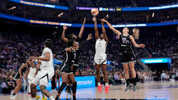 Aug 6, 2025; San Francisco, California, USA; Las Vegas Aces guard Jackie Young (0) shoots the ball between Golden State Valkyries guard Tiffany Hayes (15) and forward Cecilia Zandalasini (24) in the second quarter at the Chase Center.