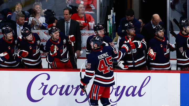 Jan 24, 2026; Winnipeg, Manitoba, CAN; Winnipeg Jets forward Cole Koepke (45) is congratulated by his teammates on his goal against the Detroit Red Wings during the second period at Canada Life Centre. Mandatory Credit: Terrence Lee-Imagn Images