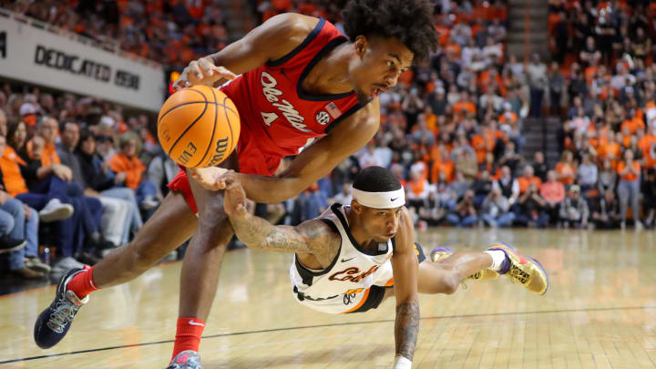 Oklahoma State Cowboys guard Avery Anderson III (0) dives for the ball under Ole Miss forward Jaemyn Brakefield (4) during a men's college basketball game between the Oklahoma State Cowboys (OSU) and the Ole Miss Rebels at Gallagher-Iba Arena in Stillwater, Okla., Saturday, Jan. 28, 2023.