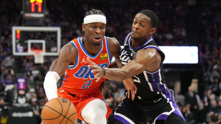 Dec 14, 2023; Sacramento, California, USA; Oklahoma City Thunder guard Shai Gilgeous-Alexander (2) dribbles against Sacramento Kings guard De'Aaron Fox (right) during the fourth quarter at Golden 1 Center. Mandatory Credit: Darren Yamashita-USA TODAY Sports