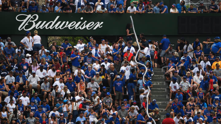 Jun 20, 2021; Chicago, Illinois, USA; Chicago Cubs fans carry stacked up empty cups during the game