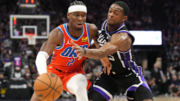 Dec 14, 2023; Sacramento, California, USA; Oklahoma City Thunder guard Shai Gilgeous-Alexander (2) dribbles against Sacramento Kings guard De'Aaron Fox (right) during the fourth quarter at Golden 1 Center. Mandatory Credit: Darren Yamashita-USA TODAY Sports