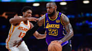 Jan 3, 2025; Los Angeles, California, USA; Los Angeles Lakers forward LeBron James (23) moves the ball against Atlanta Hawks forward De'Andre Hunter (12) during the second half at Crypto.com Arena. Mandatory Credit: Gary A. Vasquez-Imagn Images