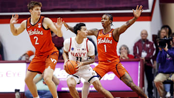 Dec 15, 2024; Blacksburg, Virginia, USA; Navy Midshipmen forward Donovan Draper (11) drives to the basket against Virginia Tech Hokies forward Tobi Lawal (1) and guard Jaden Schutt (2) during the first half at Cassell Coliseum. Mandatory Credit: Peter Casey-Imagn Images