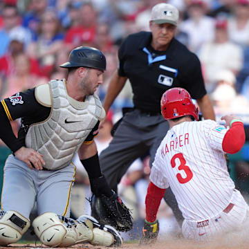 May 17, 2025; Philadelphia, Pennsylvania, USA; Pittsburgh Pirates catcher Joey Bart (14) tags Philadelphia Phillies infielder Bryce Harper (3) out at home in the first inning at Citizens Bank Park. Mandatory Credit: Kyle Ross-Imagn Images