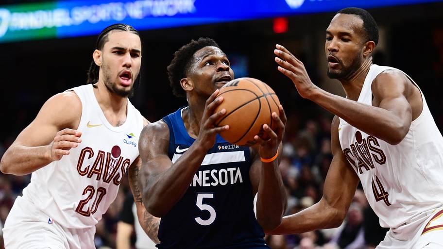 Minnesota Timberwolves guard Anthony Edwards drives to the basket between Cleveland Cavaliers Jaylon Tyson and Evan Mobley.