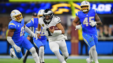 Dec 8, 2025; Inglewood, California, USA; Philadelphia Eagles quarterback Jalen Hurts (1) runs against the Los Angeles Chargers in the overtime at SoFi Stadium. Mandatory Credit: Gary A. Vasquez-Imagn Images