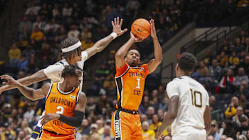 Jan 4, 2025; Morgantown, West Virginia, USA; Oklahoma State Cowboys guard Bryce Thompson (1) shoots a three-point shot during the second half against the West Virginia Mountaineers at WVU Coliseum. Mandatory Credit: Ben Queen-Imagn Images