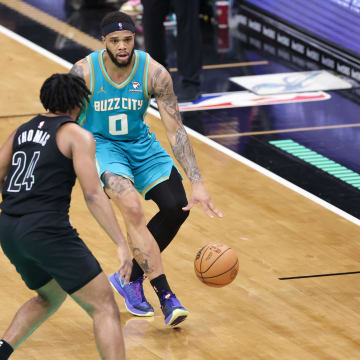 Mar 9, 2024; Charlotte, North Carolina, USA;  Charlotte Hornets forward Miles Bridges (0) sets the play against Brooklyn Nets guard Cam Thomas (24) during the fourth quarter at Spectrum Center. Mandatory Credit: Cory Knowlton-USA TODAY Sports