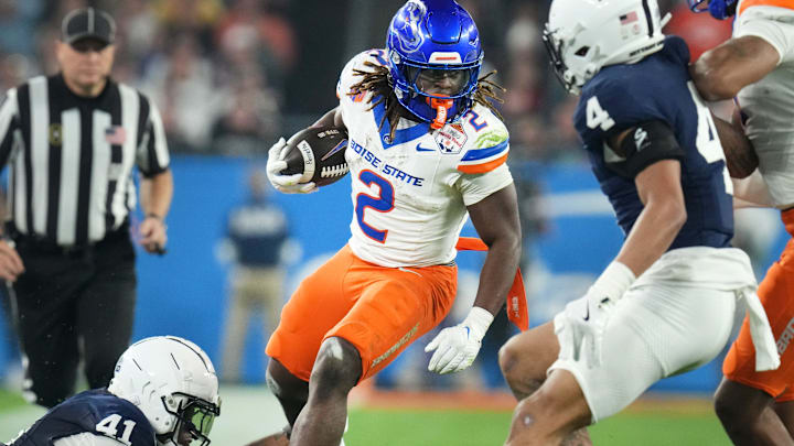 Boise State Broncos running back Ashton Jeanty (2) runs past Penn State Nittany Lions linebacker Kobe King (41) during their Vrbo Fiesta Bowl matchup at State Farm Stadium on Dec. 31, 2024.