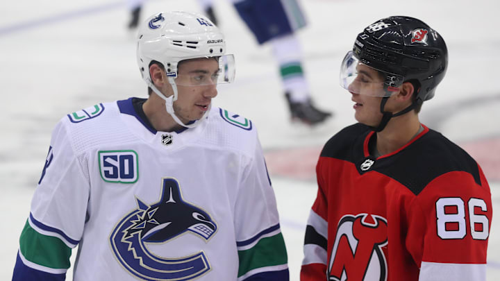 Oct 19, 2019; Newark, NJ, USA; Vancouver Canucks defenseman Quinn Hughes (43) and New Jersey Devils center Jack Hughes (86) talk during warmups for their NHL game at Prudential Center. Mandatory Credit: Ed Mulholland-Imagn Images