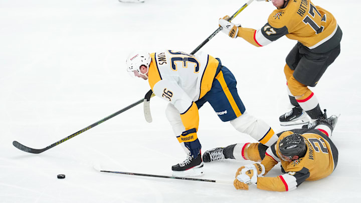 Dec 31, 2025; Las Vegas, Nevada, USA; Nashville Predators left wing Cole Smith (36) breaks away from Vegas Golden Knights defenseman Ben Hutton (17) and defenseman Zach Whitecloud (2) during the third period at T-Mobile Arena. Mandatory Credit: Stephen R. Sylvanie-Imagn Images