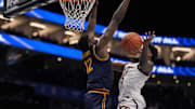 Virginia Tech Hokies guard Jaydon Young loses the ball under pressure from California Golden Bears center Mady Sissoko.