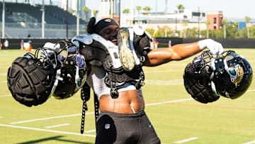Jacksonville Jaguars rookie and defensive end BJ Green II (95) carries other player’s gear back to the locker room on the first day of pads, after practice during an NFL training camp fifth session at the Miller Electric Center, Monday, July 28, 2025, in Jacksonville, Fla.