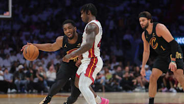 Apr 28, 2025; Miami, Florida, USA; Cleveland Cavaliers guard Donovan Mitchell (45) drives the basketball against Miami Heat guard Davion Mitchell (45) in the second quarter during game four for the first round of the 2025 NBA Playoffs at Kaseya Center. Mandatory Credit: Sam Navarro-Imagn Images