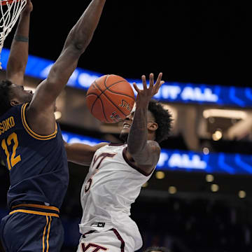 Virginia Tech Hokies guard Jaydon Young loses the ball under pressure from California Golden Bears center Mady Sissoko.