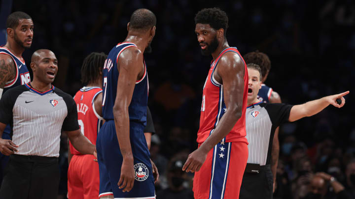 Dec 30, 2021; Brooklyn, New York, USA; Philadelphia 76ers center Joel Embiid (21) and Brooklyn Nets forward Kevin Durant (7) stare each other down during the second half at Barclays Center. Mandatory Credit: Vincent Carchietta-USA TODAY Sports