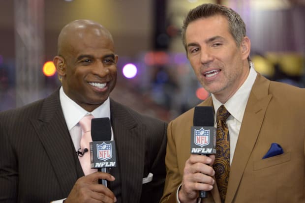 Jan 26, 2015; Phoenix, AZ, USA; Deion Sanders (L) and Kurt Warner (R) smiles during NFL Network broadcast at the NFL Experien