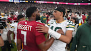 Arizona Cardinals quarterback Jacoby Brissett (7) embraces Green Bay Packers quarterback Jordan Love (10) after the Packers' 27-23 win over the Cardinals at State Farm Stadium in Glendale on Oct. 19, 2025.