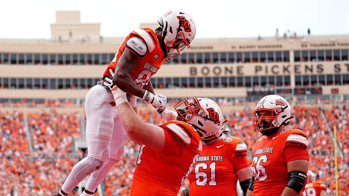 Oklahoma State's Brennan Presley (80) celebrates his touchdown with Cole Birmingham (67) first half of the college football game between the Oklahoma State Cowboys and South Dakota State Jackrabbits at Boone Pickens Stadium in Stillwater, Okla., Saturday, Aug., 31, 2024.