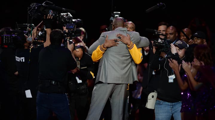 Apr 13, 2016; Los Angeles, CA, USA; Los Angeles Lakers forward Kobe Bryant (facing camera) hugs former Laker player Magic Johnson before a game against the Utah Jazz at Staples Center. Bryant concludes his 20-year NBA career tonight. Mandatory Credit: Robert Hanashiro-USA TODAY Sports