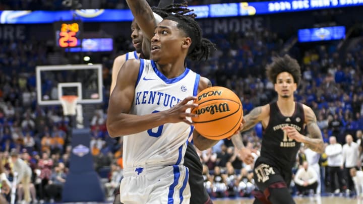 Mar 15, 2024; Nashville, TN, USA;  Kentucky Wildcats guard Rob Dillingham (0) drives past Texas A&M Aggies guard Manny Obaseki (35) during the second half at Bridgestone Arena. Mandatory Credit: Steve Roberts-USA TODAY Sports