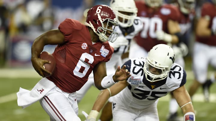 Aug 30, 2014; Atlanta, GA, USA; Alabama Crimson Tide quarterback Blake Sims (6) scrambles against West Virginia Mountaineers linebacker Nick Kwiatkoski (35)  during the second quarter of the 2014 Chick-fil-a kickoff game at Georgia Dome. Mandatory Credit: John David Mercer-Imagn Images